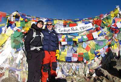 Trekkers and prayer flags in Gokyo Peak